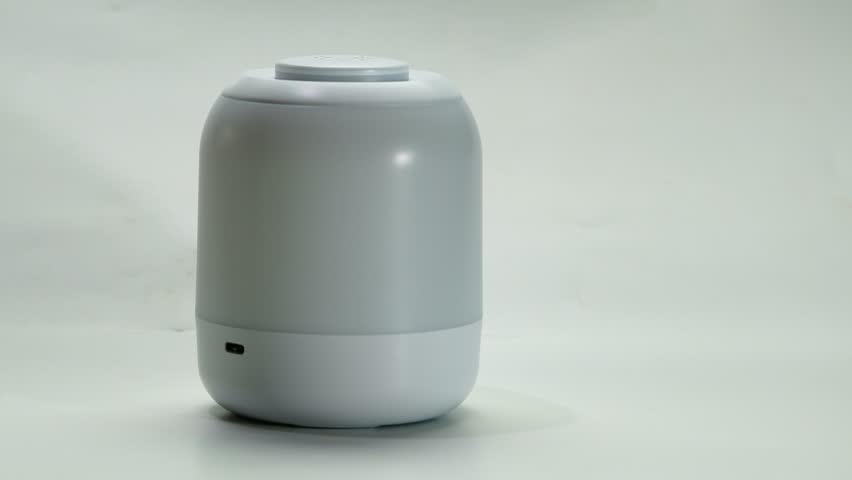Rechargeable touch control bedside multi functional night light on white background. This small desk lamp can adjust brightness level.