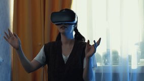 Young adult Caucasian woman uses VR headset at home enjoying interactive games and working in digital metaverse space representing advanced technology lifestyle. Mid shot. - Powered by Shutterstock - Get 15% off with code: PIKWIZARD15