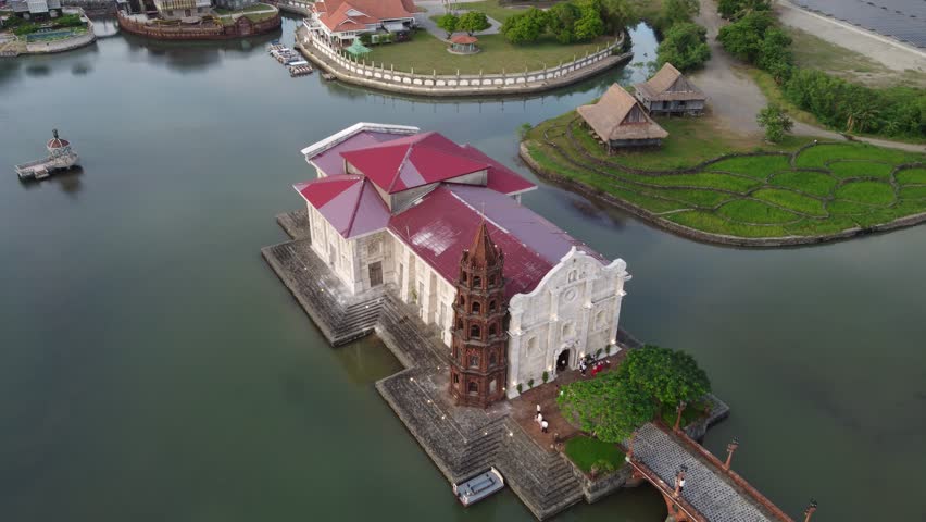 An orbiting, wide-angle, drone shot of a church in Las Casas Filipinas de Acuzar in Bataan, Philippines