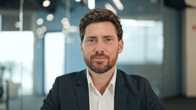 Confident businessman in a modern office, wearing a dark suit, speaks passionately during a video call. Expresses serious emotions while gesturing. - Powered by Shutterstock - Get 15% off with code: PIKWIZARD15