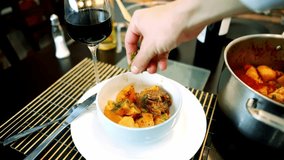 Gourmet Stew Garnished With Fresh Herbs. Served With Red Wine, Professional Culinary Presentation, Delicious Food, Fine Dining Experience, Meal Preparation, Homemade Cuisine. Cooked Vegetable Dish - Powered by Shutterstock - Get 15% off with code: PIKWIZARD15