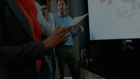 Team explaining business network diagram projecting world map overlay expanding across display. Collaboration, innovation, technology, communication, teamwork, digital, meeting - Powered by Shutterstock - Get 15% off with code: PIKWIZARD15