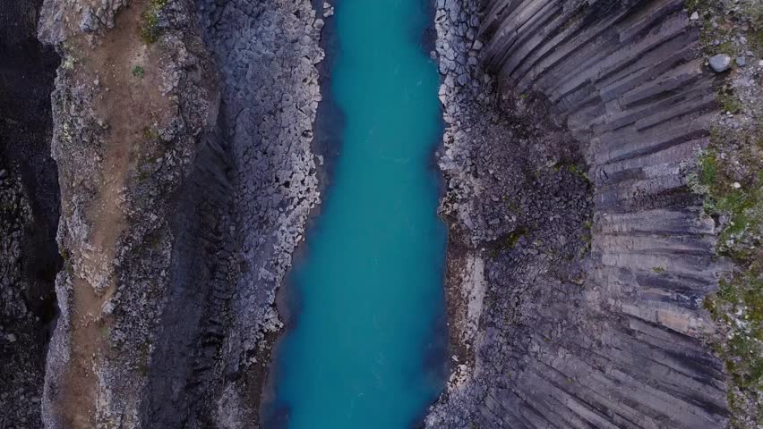 basalt canyon with a blue glacial river, famous studlagil in the eastern highlands	