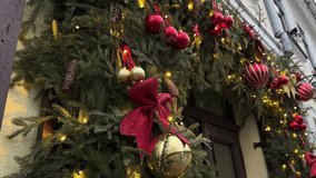 Festive street decoration adorned with evergreen garlands, red ornaments, and twinkling lights, creating a warm holiday atmosphere for New Year celebrations - Powered by Shutterstock - Get 15% off with code: PIKWIZARD15