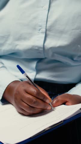 Vertical Video Close up of candidate filling in registration forms for job application and interview, ensuring a great recruitment process and successful meeting with the HR. Writes down