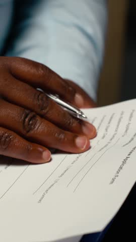 Vertical Video Close up of candidate filling in registration forms for job application and interview, ensuring a great recruitment process and successful meeting with the HR. Writes down
