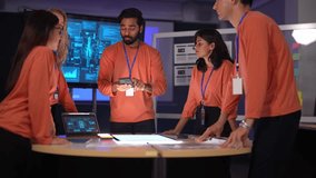 In a smart city command center, a team of engineers uses a smartphone to interact with an augmented reality overlay of live IoT data, managing city infrastructure in real time. - Powered by Shutterstock - Get 15% off with code: PIKWIZARD15