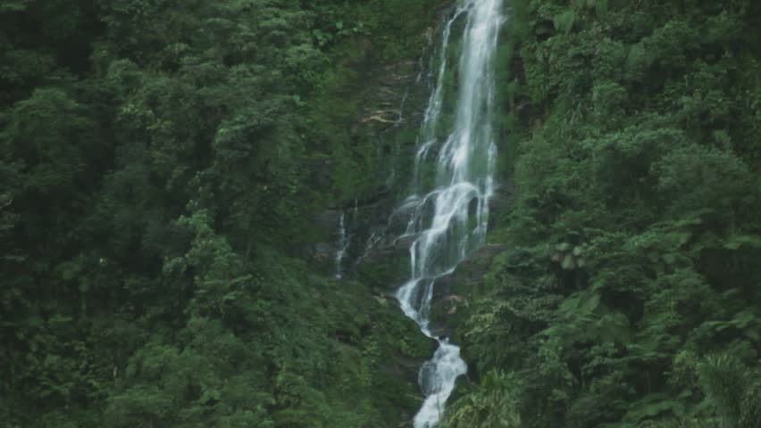 Wide shot of a beautiful and untouched waterfall in the ancient Tairona site of Ciudad Perdida, deep in the Sierra Nevada de Santa Marta, Colombia.