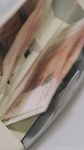 Russian ruble banknotes being rapidly counted in an automatic money counting machine.