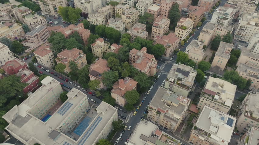 Aerial Drone View of Historic Trastevere Neighborhood Rome Italy on Overcast Day - Medieval Streets and Rooftops Under Dramatic Cloudy Sky