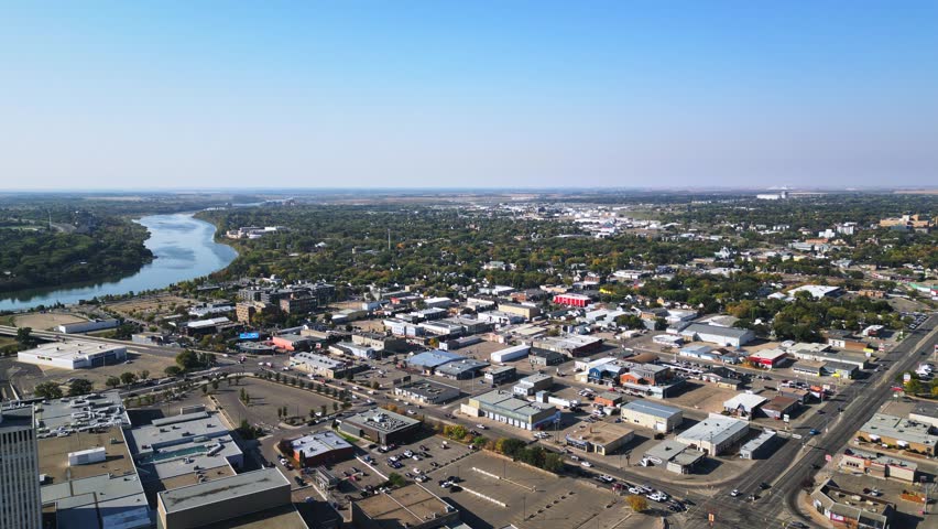 Aerial shows southern Saskatoon riverfront with new developments in autumn