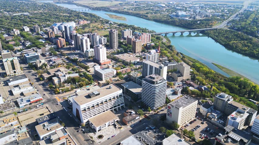 Aerial orbit of Saskatoon downtown in fall, streets, traffic, bridge, buildings