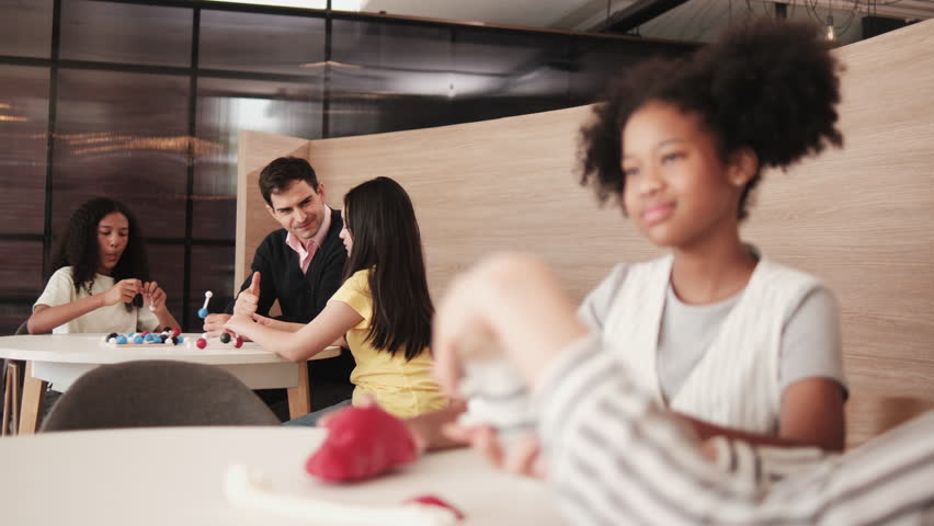 Group of student girls brainstorm and discuss with their teachers