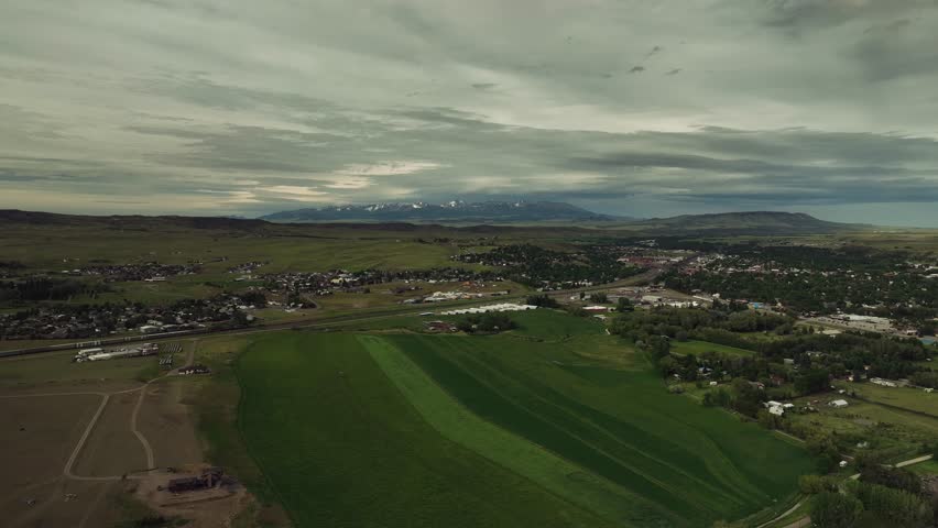 Aerial drone view of mountains, fields, and rural landscape in Montana, USA