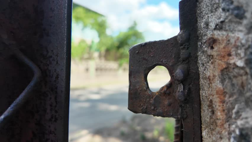 old rusty iron door. old lock. old rusty lock on the door. Rusty iron, fences of houses with debris around the beach, residential areas that were flooded