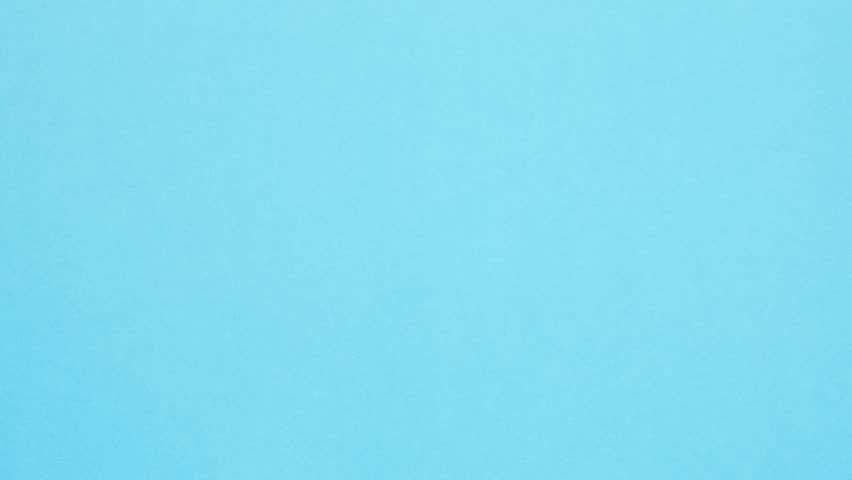 Yellow crumpled paper unfolds then refolds on blue in stop motion transition