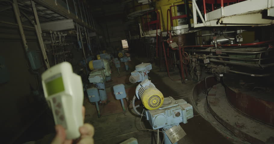 Person Holds A Radiation Detector With Circulation Pumps Within The Chernobyl Nuclear Power Plant In Ukraine. - handheld shot