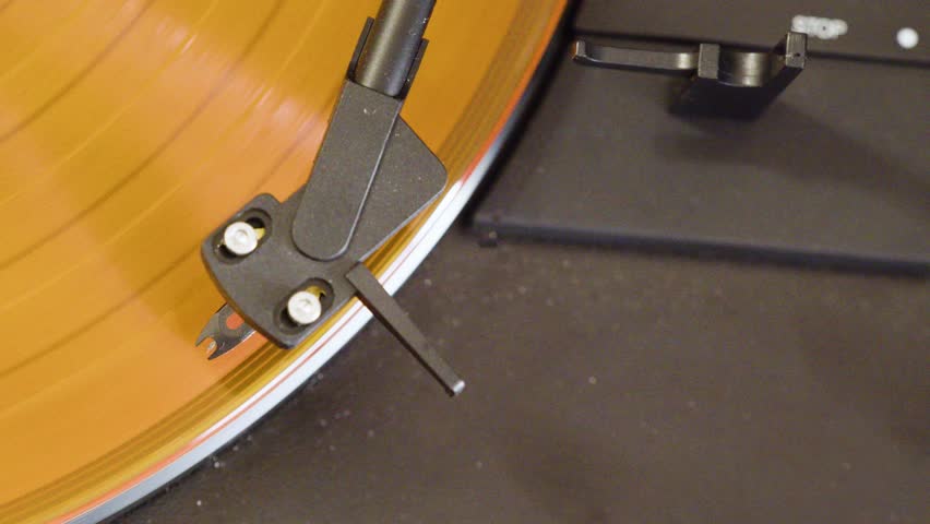 Turntable disk vinyl record player close-up 4K footage. Close-up 4K shot of a vinyl record spinning on a classic turntable player.