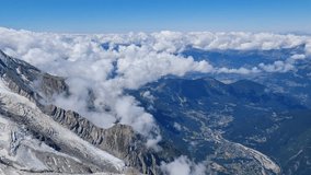 Breathtaking Panoramic View of Mountain Valley and Peaks Above a Sea of Clouds on a Sunny Day. - Powered by Shutterstock - Get 15% off with code: PIKWIZARD15