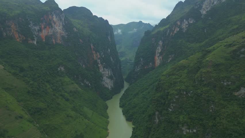 Stunning aerial view of a thin green mountain valley with rocky outcrops at Nho Que River, Ha Giang, Vietnam