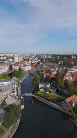 Aerial view of the Opera Nova theater and the contrasting river reflecting the sky in the city, Bydgoszcz, Województwo kujawsko-pomorskie, Poland.