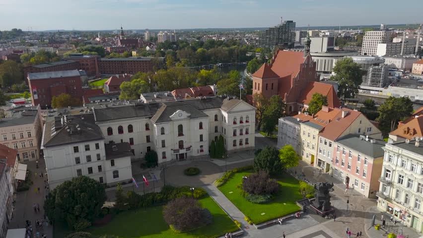 Aerial view of the Opera Nova and Młyny Rothera along the river, where the contrasting architecture meets lush green trees, Bydgoszcz, Kuyavian-Pomeranian Voivodeship, Poland.