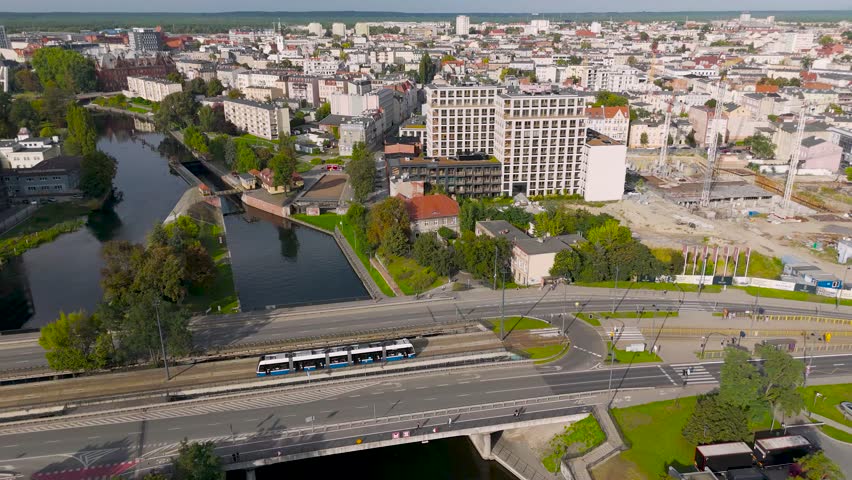 Aerial view of a modern tram on the street surrounded by buildings, contrasting with the urban landscape, Bydgoszcz, Kuyavian-Pomeranian Voivodeship, Poland.