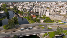Aerial view of a modern tram on the street surrounded by buildings, contrasting with the urban landscape, Bydgoszcz, Kuyavian-Pomeranian Voivodeship, Poland. - Powered by Shutterstock - Get 15% off with code: PIKWIZARD15