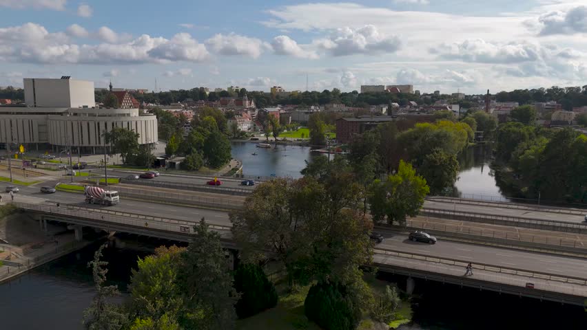 Aerial view of the Opera Nova contrasting with the lush green trees and the bridge carrying a tram, Bydgoszcz, Kuyavian-Pomeranian Voivodeship, Poland.