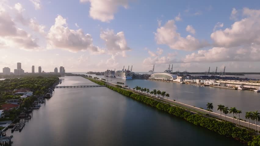 Aerial view of MacArthur Causeway, where emerald green trees meet the deep blue sea near the port, Miami, Florida, United States.