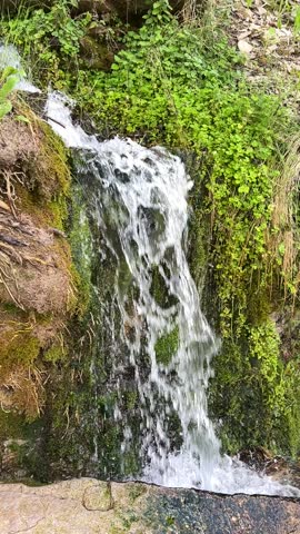 Mountain waterfall on a stormy river. Slow motion video