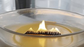 Large scented candle in glass jar burning in cozy autumn home interior, warm hygge atmosphere, aromatherapy close up - Powered by Shutterstock - Get 15% off with code: PIKWIZARD15