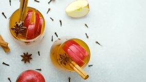 Warm apple cider with cinnamon sticks, star anise, and apple slices in glasses - Powered by Shutterstock - Get 15% off with code: PIKWIZARD15