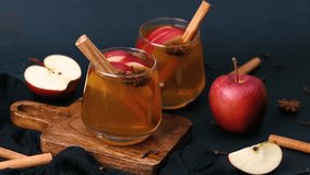 Warm apple cider with cinnamon sticks and star anise in glasses, served with fresh apples. - Powered by Shutterstock - Get 15% off with code: PIKWIZARD15