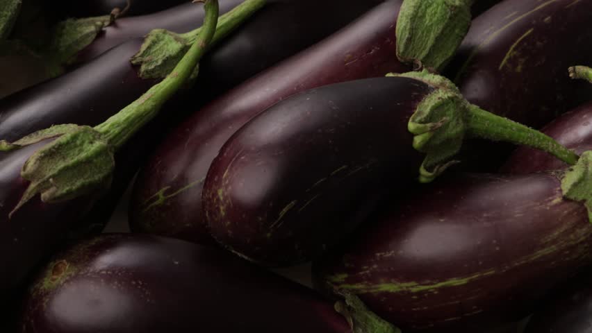close up of uncooked eggplant in wooden crate zoom food