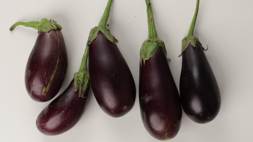 harvest of organic eggplants food light background zoom