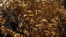 Close-up curly spiral metal shavings accumulating from industrial machining process. Residues from production at metalworking enterprise in metallurgical industry. Metal production factory. - Powered by Shutterstock - Get 15% off with code: PIKWIZARD15