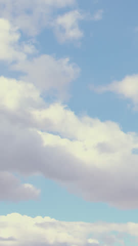 A tranquil time-lapse from an airplane window shows soft white clouds drifting over a deep blue sky, capturing serene aerial motion and expansive natural beauty, perfect for travel or relaxation theme