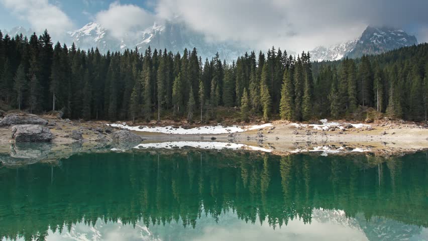 Lago di Carezza in the Dolomites: mountain lake and pine forest ladscape time lapse, South Tyrol, Italy