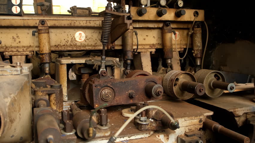 Old industrial machine equipment in lumber mill workshop on factory. Wood manufacturing and carpentry on plant, timber industry. Many broken metal details parts. Woodworking production manufacturing.