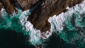Strong Waves Crashing Against the Rugged Coastline And Cliffs Of Island. - aerial topdown shot - Powered by Shutterstock - Get 15% off with code: PIKWIZARD15