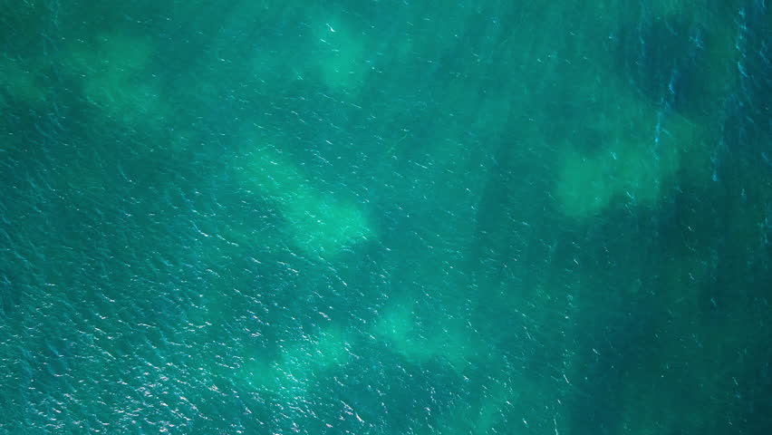 Aerial view of turquoise Mediterranean Sea surface near Alicante, Spain. Abstract natural water texture with sunlight reflections and copy space. High quality 4k footage