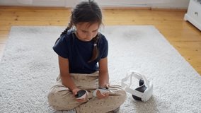 A young girl interacts with VR controllers, exploring the world of virtual reality gaming playfully.Slow motion - Powered by Shutterstock - Get 15% off with code: PIKWIZARD15