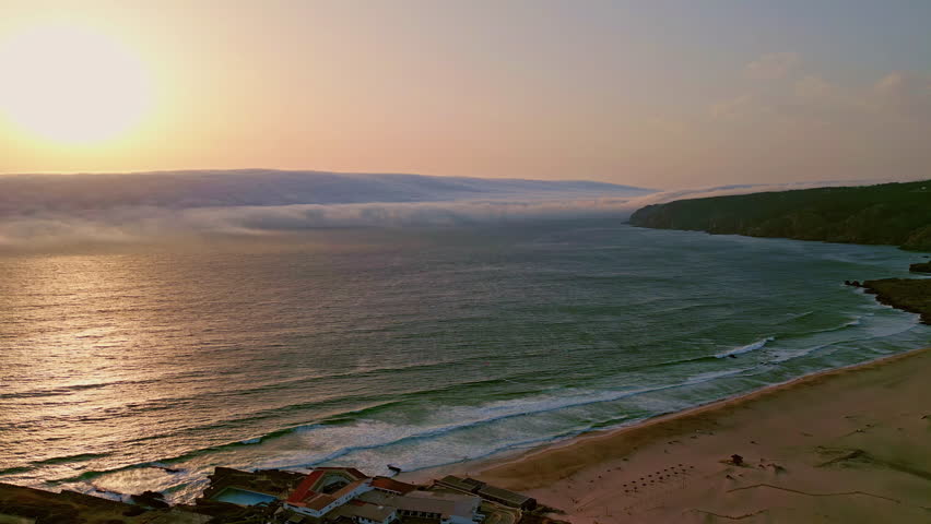 Breathtaking marine sunset shining over deep ocean water drone view. Golden sun setting over calm sea horizon at summer evening. Aerial shot bright sunlight illuminating in waves rolling on sand beach