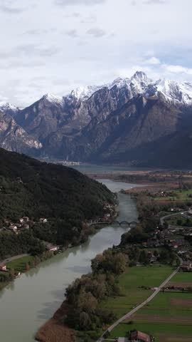 A Serene River Flowing Through a Picturesque Green Valley in Aerial View