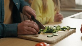 Unrecognizable family at kitchen close up father cooking prepare cut vitamin salad Caucasian daughter child girl kid with dad waiting breakfast food delivery childcare bonding dinner time at home - Powered by Shutterstock - Get 15% off with code: PIKWIZARD15