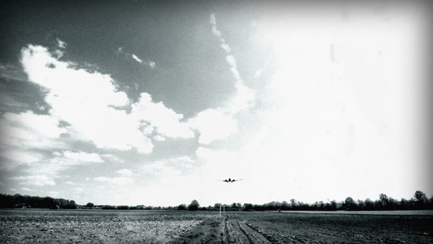 An 8mm (faked) Black & White shot. Historic airplane, Junkers JU 52 (Nickname "Tante JU") fly over and landing. No recognizable people, trademarks or logos! 10921 

