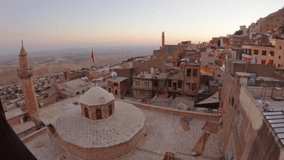 Mardin, Turkey - 16th august: 2025: Timelapse zoom in Sunset panorama over Mardin Old Town, stone rooftops, domes, minarets, warm street lights, Mesopotamian plain to horizon, heritage limestone - Powered by Shutterstock - Get 15% off with code: PIKWIZARD15