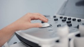Close up of doctor hand adjusting ultrasound machine - Powered by Shutterstock - Get 15% off with code: PIKWIZARD15