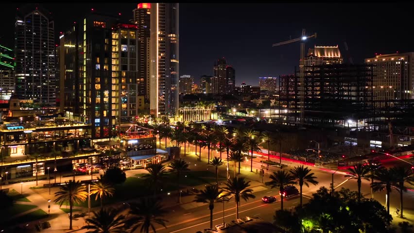 Breathtaking aerial time lapse of downtown San Diego at night, aerial capture over intersection with Embarcadero city glow